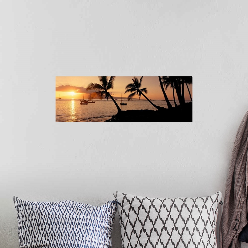 A bohemian room featuring Panoramic photograph of a colorful sunset in the town of Lahaina on the island of Maui in Hawaii....