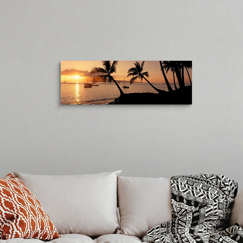 A bohemian room featuring Panoramic photograph of a colorful sunset in the town of Lahaina on the island of Maui in Hawaii....
