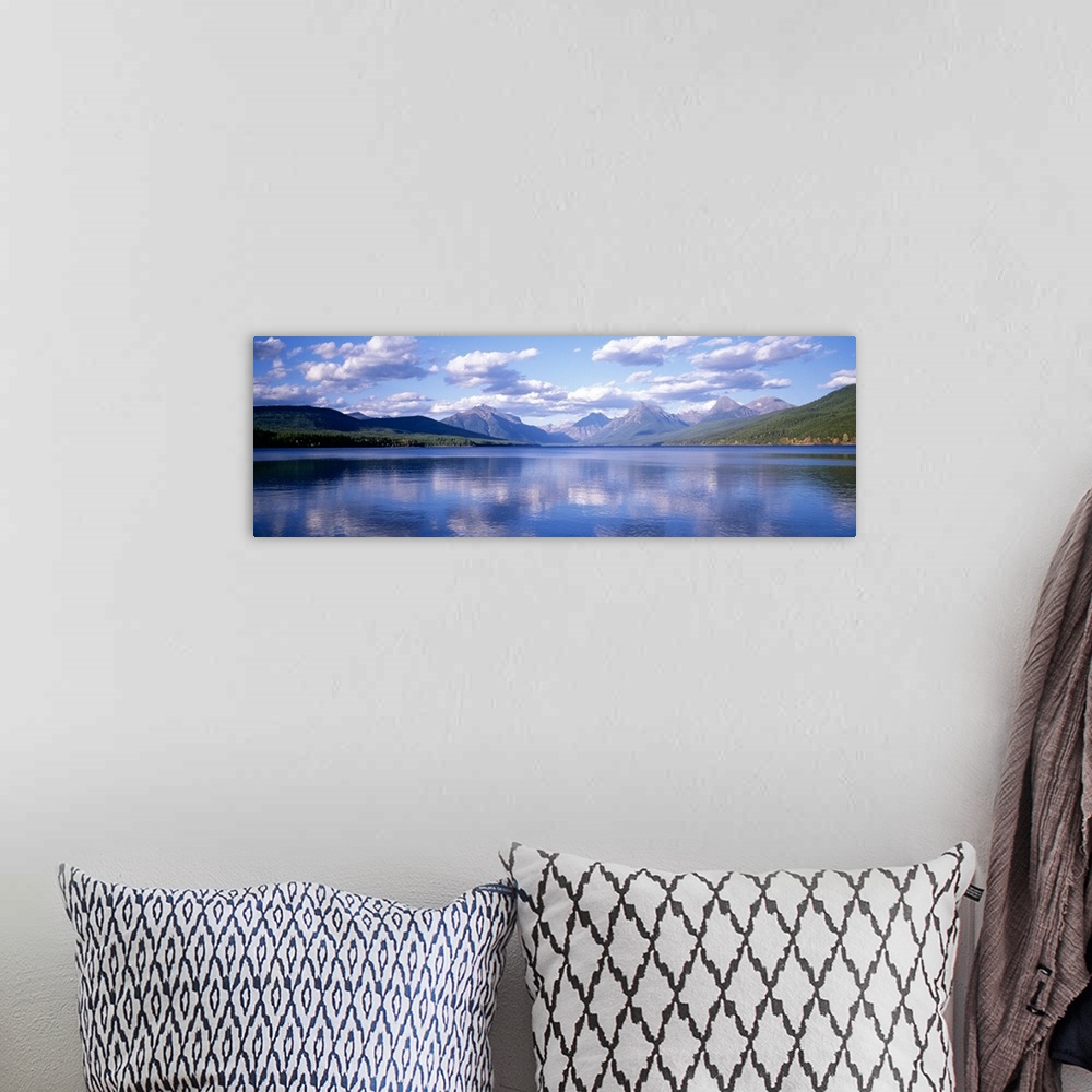 A bohemian room featuring Panoramic photograph Lake McDonald with small ripples in the water reflecting the mountains and t...