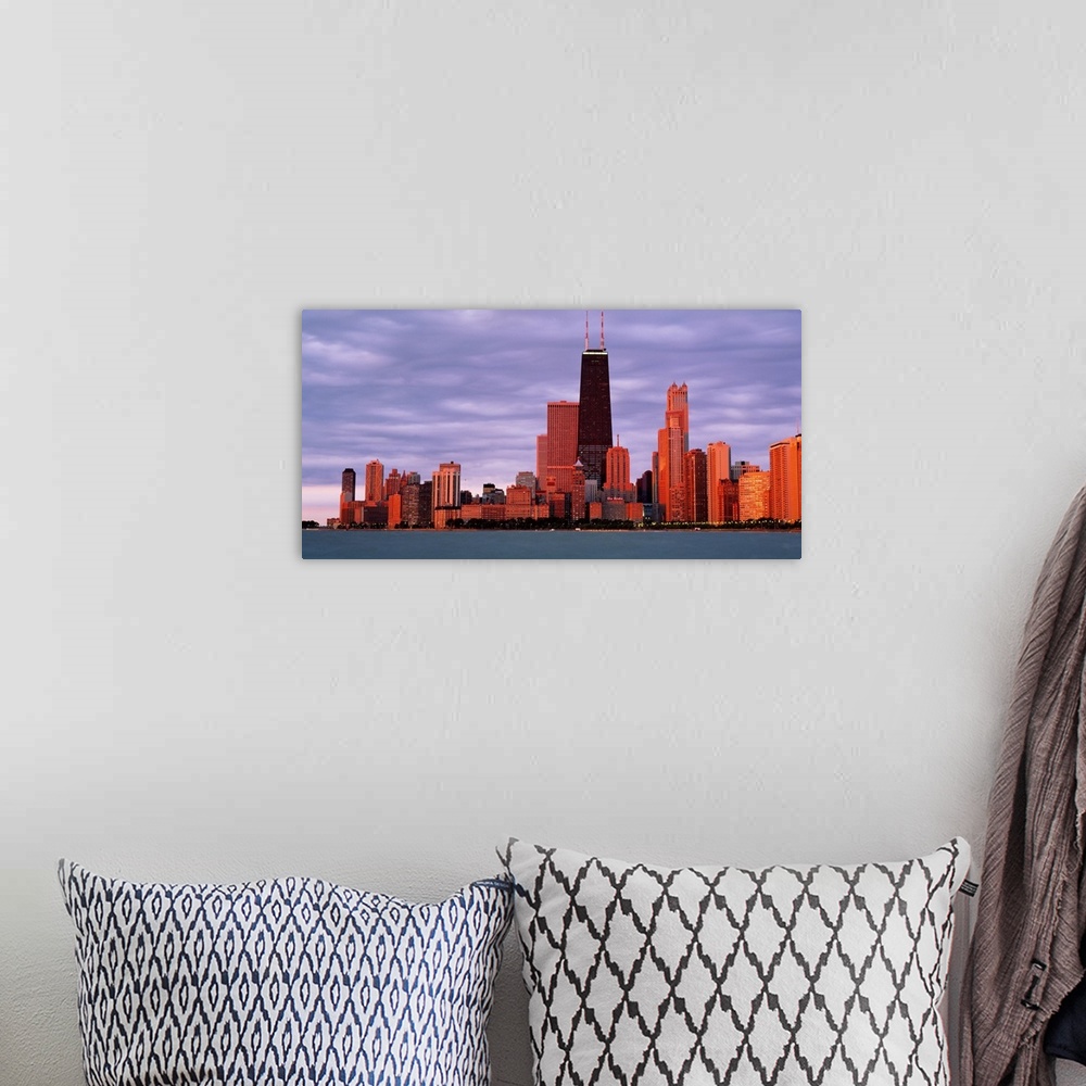 A bohemian room featuring This landscape wall art captures the city skyline from the lake in the fading sunlight of the eve...