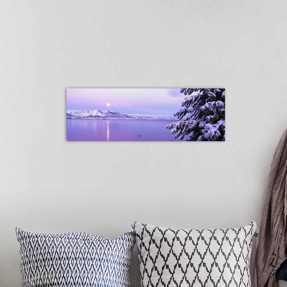 A bohemian room featuring Wide angle photograph of the sun setting over Lake Tahoe, snow covered mountains in the backgroun...
