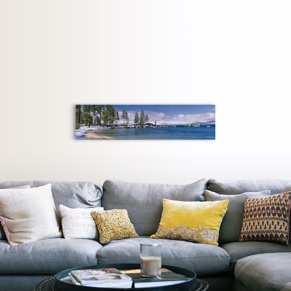 A farmhouse room featuring This large panoramic piece is a photograph of the Lake Tahoe coast. Pine trees line the snow cove...
