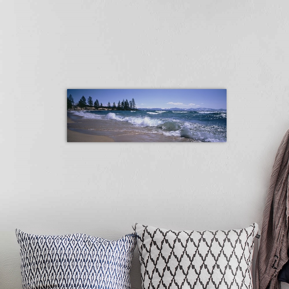 A bohemian room featuring Panoramic photograph shows the waves of a large body of water in Nevada crashing against a sandy ...