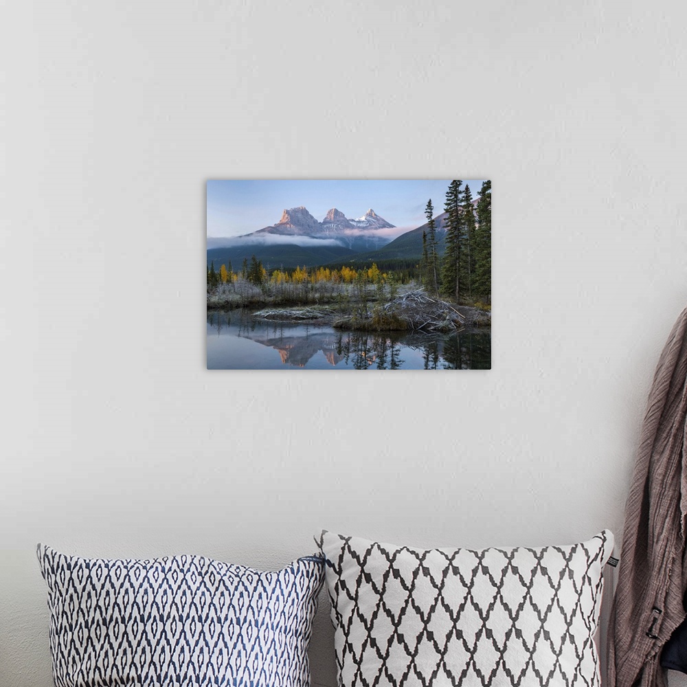 A bohemian room featuring Lake with mountains in background, Beaverlodge, Three Sisters, Canmore, Alberta, Canada.