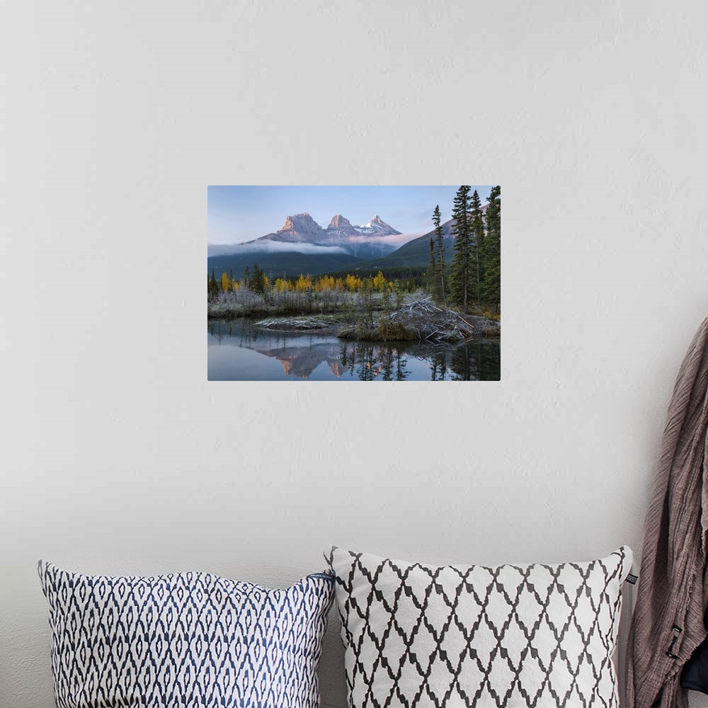 A bohemian room featuring Lake with mountains in background, Beaverlodge, Three Sisters, Canmore, Alberta, Canada.