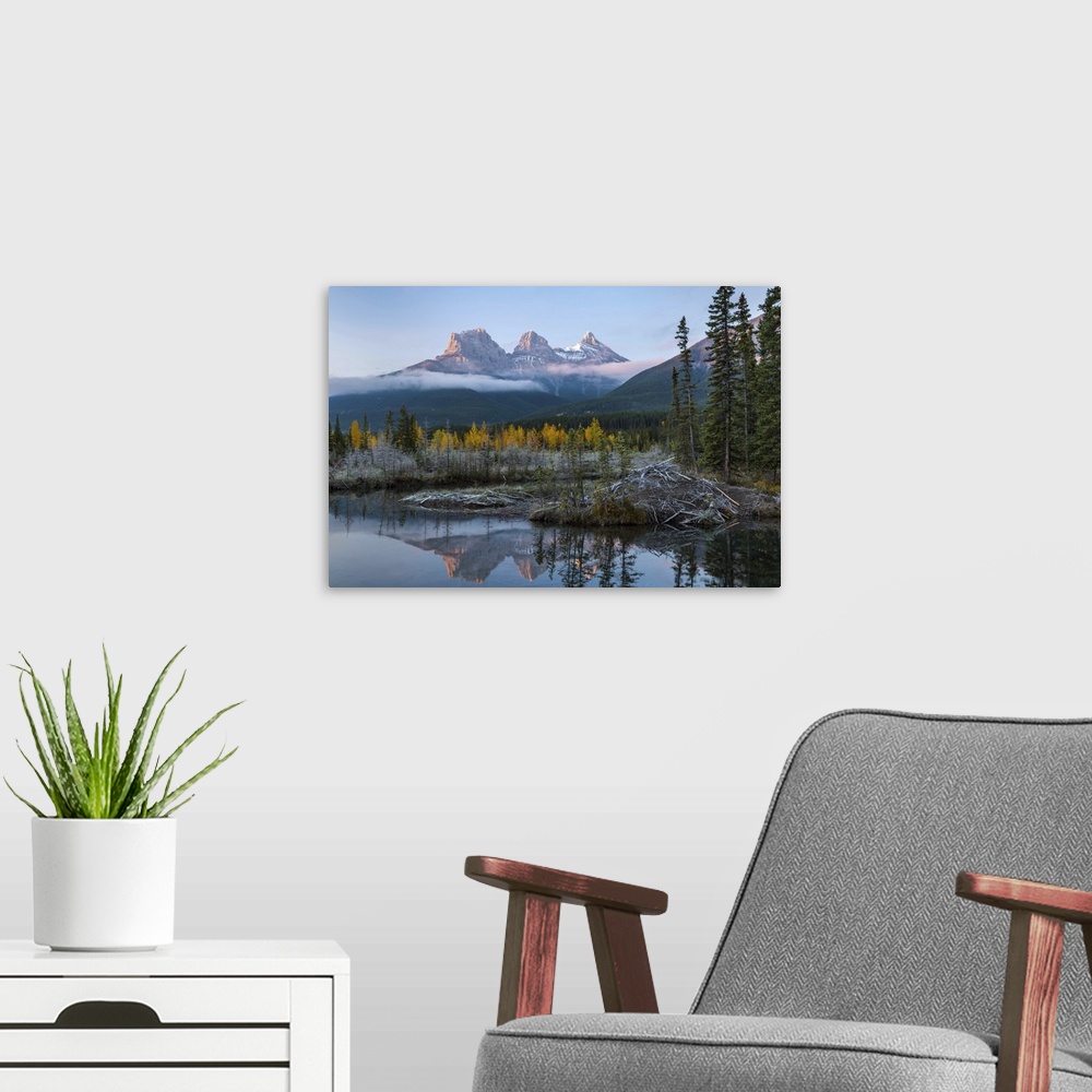 A modern room featuring Lake with mountains in background, Beaverlodge, Three Sisters, Canmore, Alberta, Canada.