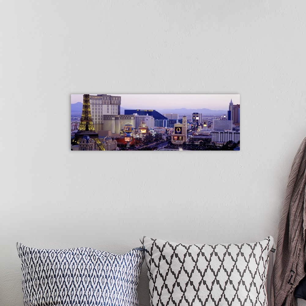 A bohemian room featuring Panoramic photograph of ""Sin City"" skyline with mountains in the distance.  The buildings are l...