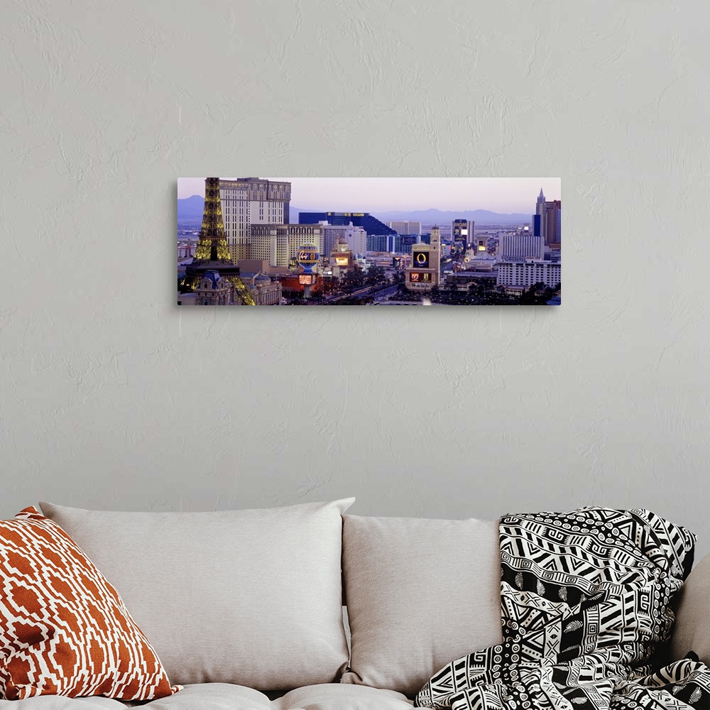 A bohemian room featuring Panoramic photograph of ""Sin City"" skyline with mountains in the distance.  The buildings are l...