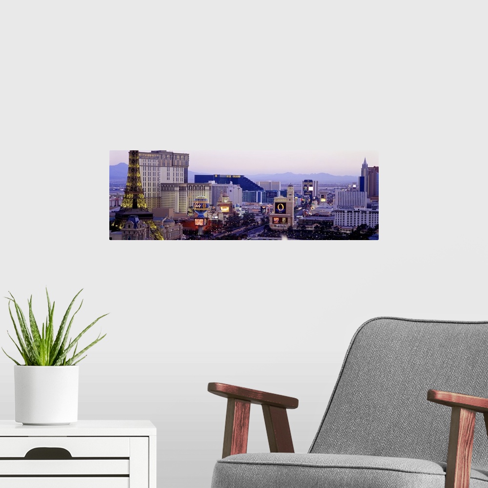 A modern room featuring Panoramic photograph of ""Sin City"" skyline with mountains in the distance.  The buildings are l...