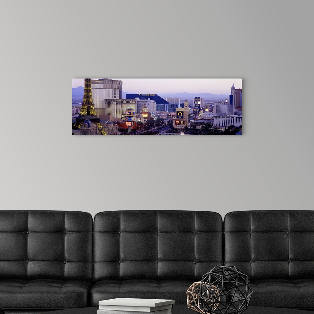 A modern room featuring Panoramic photograph of ""Sin City"" skyline with mountains in the distance.  The buildings are l...