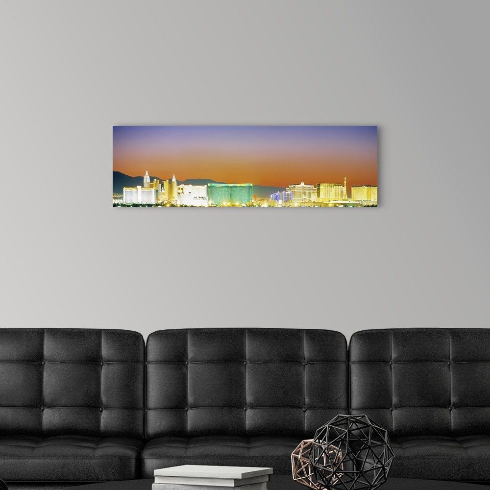 A modern room featuring Panoramic photograph taken from a distance focuses on a selection of brightly shining casinos, bu...