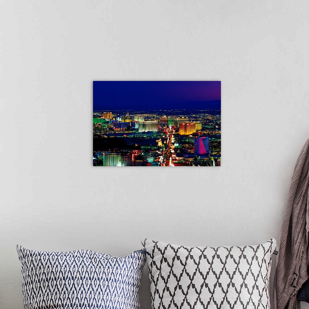 A bohemian room featuring View from above of the Las Vegas strip its neon lights glowing in the night sky in a horizontal p...