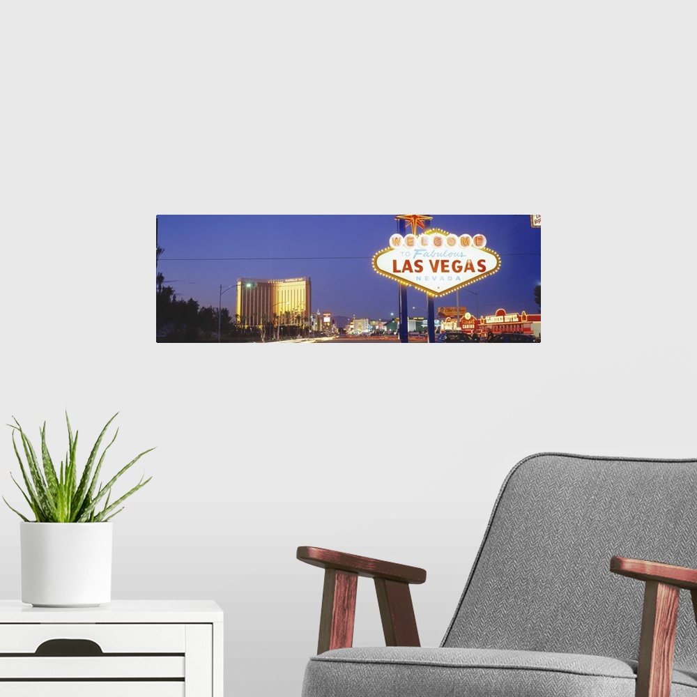 A modern room featuring Giant photograph shows the famous neon sign that welcomes people as they enter the nicknamed "Sin...