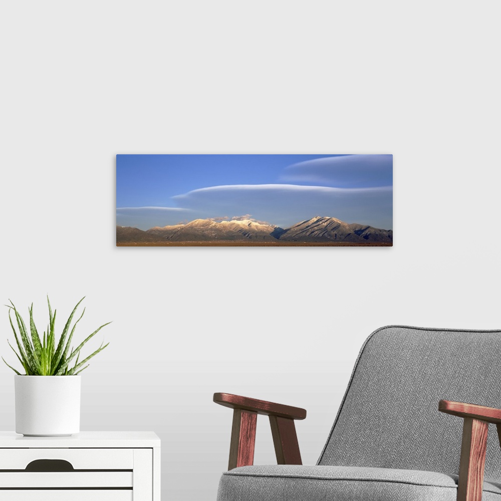 A modern room featuring Lenticular clouds over a mountain range Taos Mountains Sangre de Cristo Range New Mexico