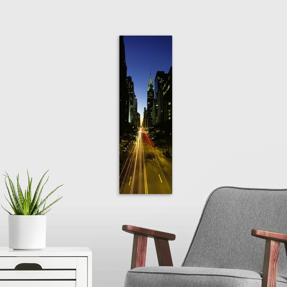 A modern room featuring Large vertical panoramic photo of blended car headlights in motion on Lexington Avenue in New Yor...