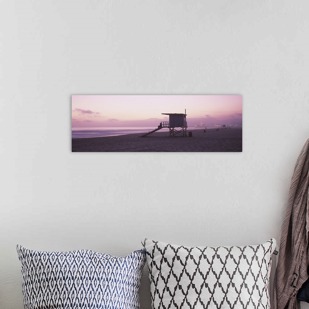 A bohemian room featuring Long horizontal photo print of a lifeguard station on the beach along the Pacific ocean with the ...