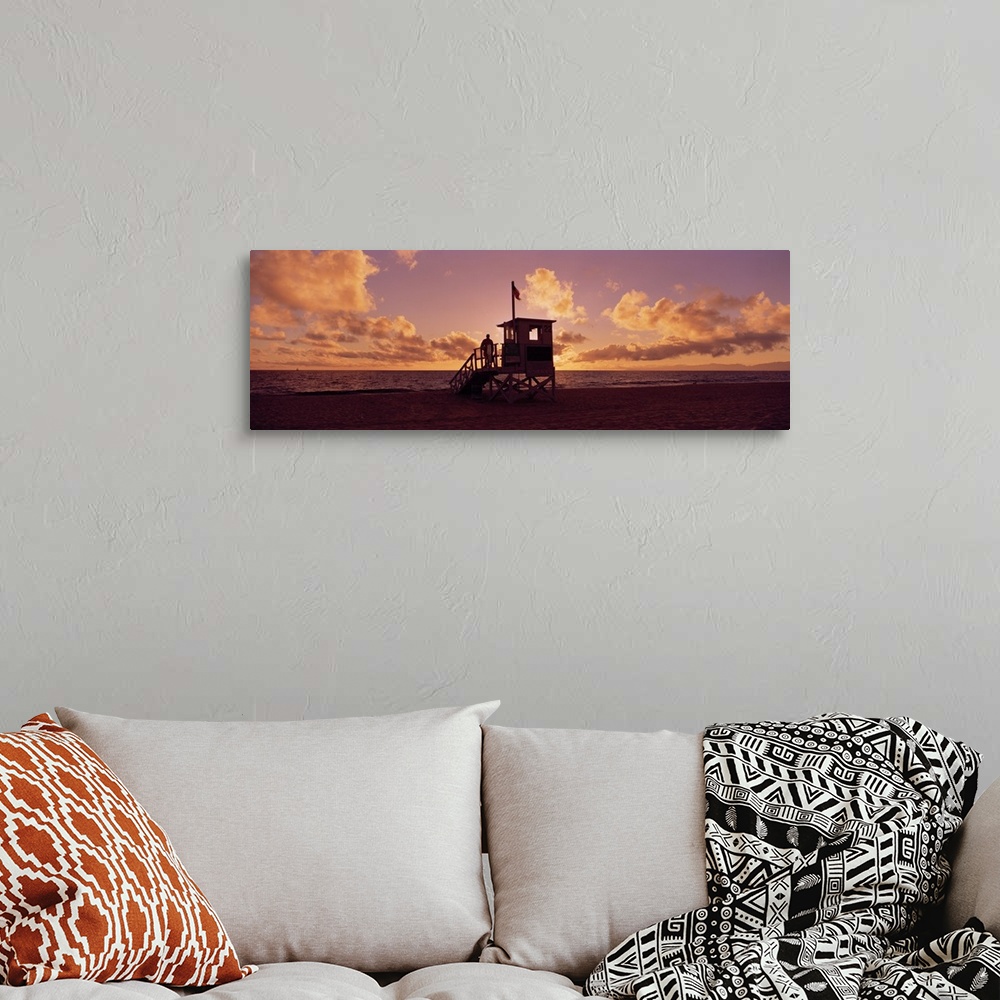 A bohemian room featuring Landscape photograph on a big canvas of the 22nd Street lifeguard station on Redondo Beach, silho...