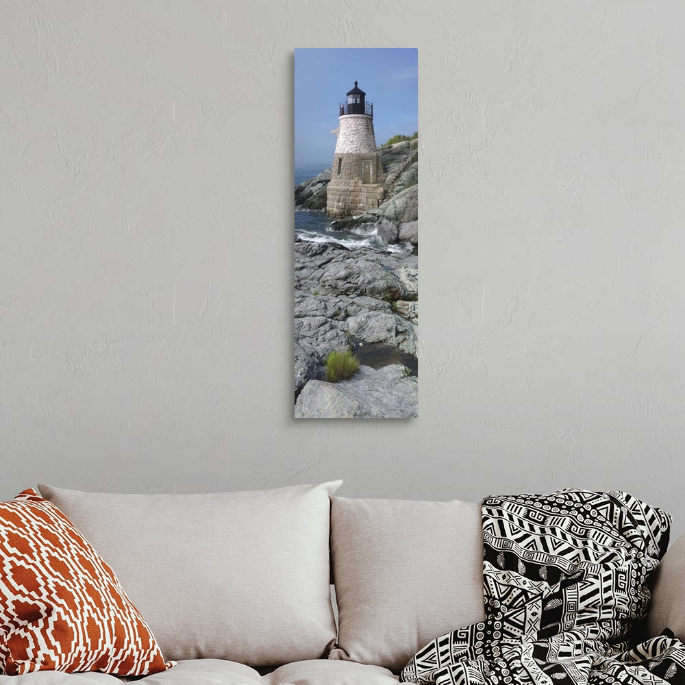 A bohemian room featuring This is a vertical photograph of light house on a rocky coast.