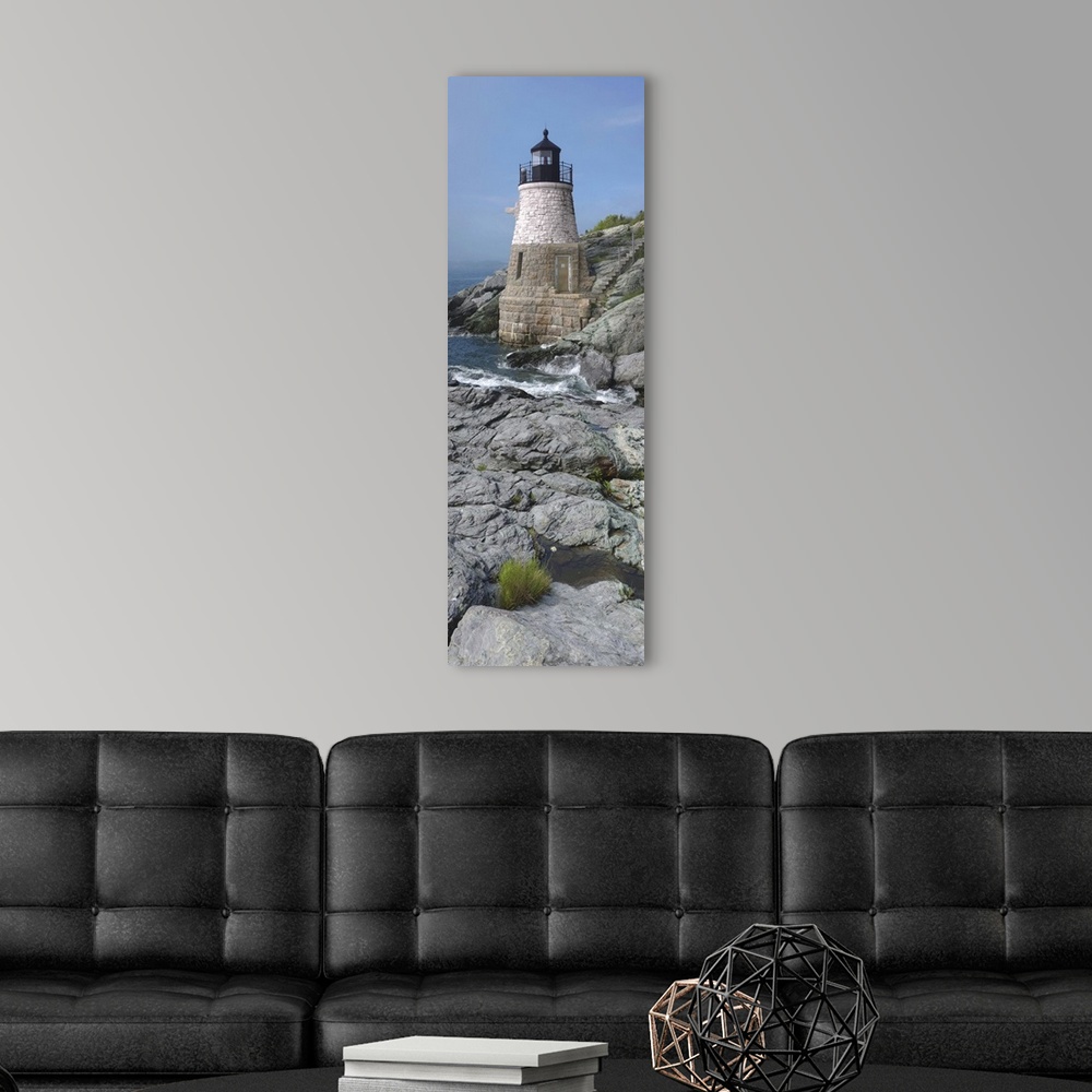 A modern room featuring This is a vertical photograph of light house on a rocky coast.