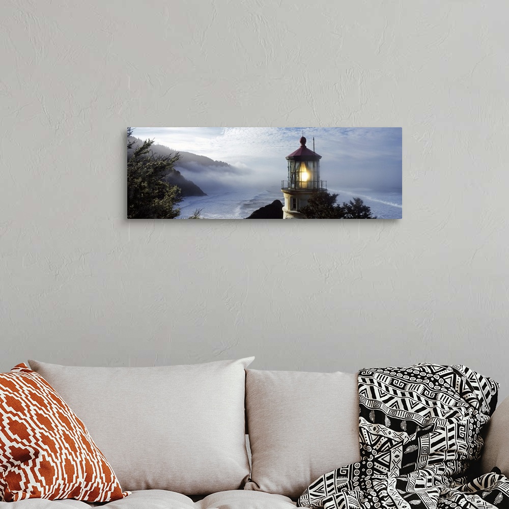 A bohemian room featuring Big panoramic photograph of the Heceta Head Lighthouse and trees on a cliff overlooking Heceta He...