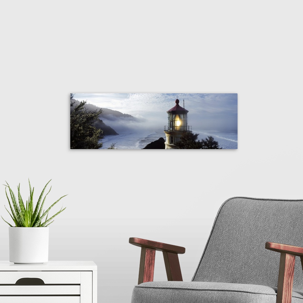 A modern room featuring Big panoramic photograph of the Heceta Head Lighthouse and trees on a cliff overlooking Heceta He...