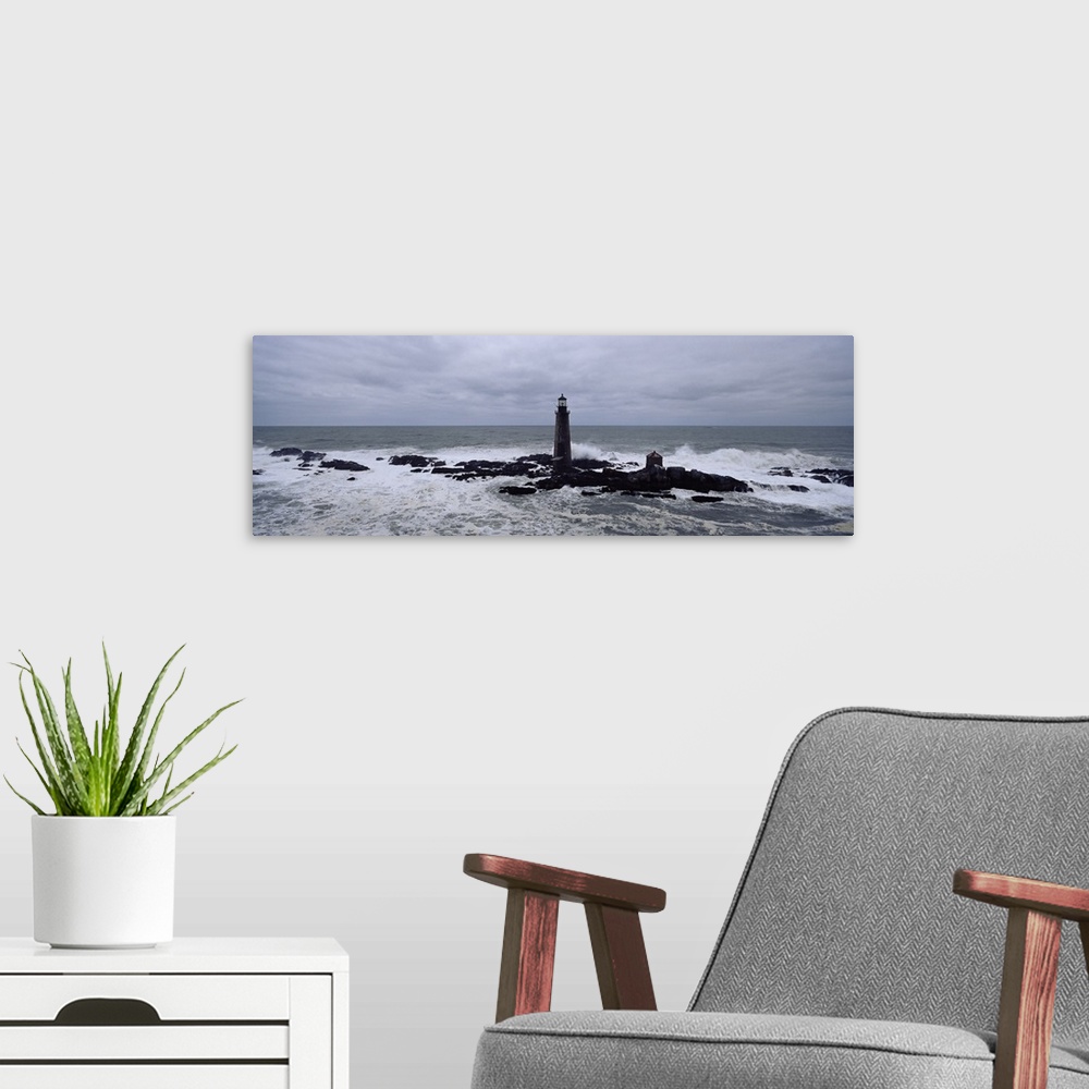 A modern room featuring This decorative wall art is a panoramic photograph taken on an overcast day of a lighthouse built...