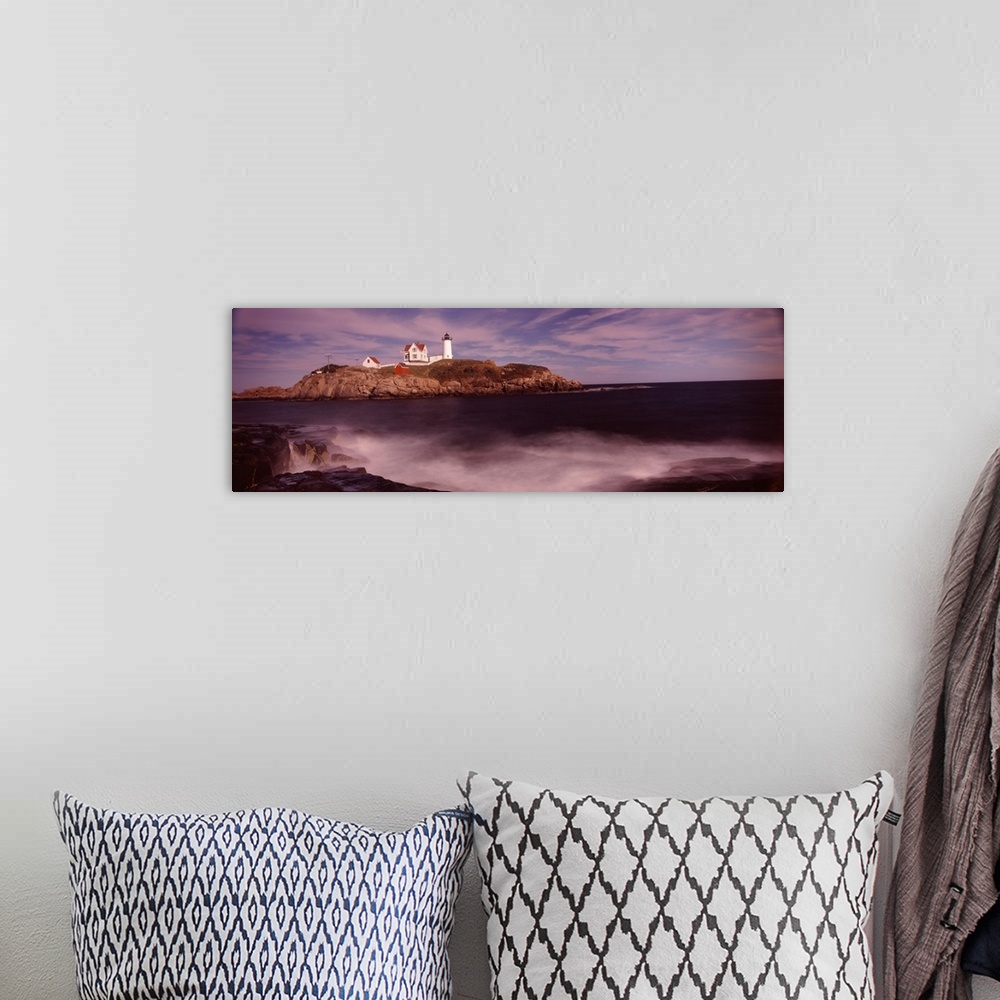 A bohemian room featuring Panoramic photograph of Nubble Lighthouse on top of a rocky hillside, along the coast of York, Ma...