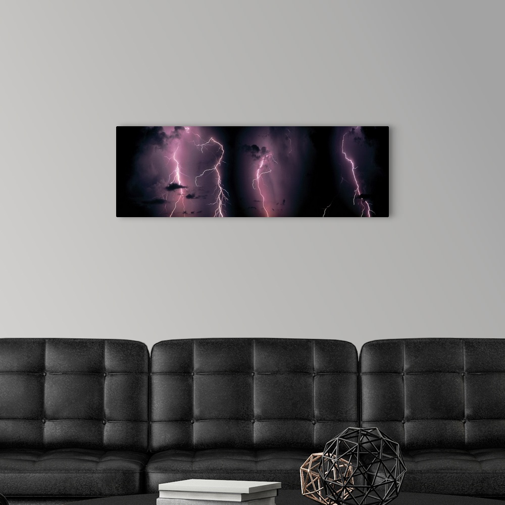 A modern room featuring Oversized, landscape photograph of numerous bolts of lightening, displaying clouds in the night s...