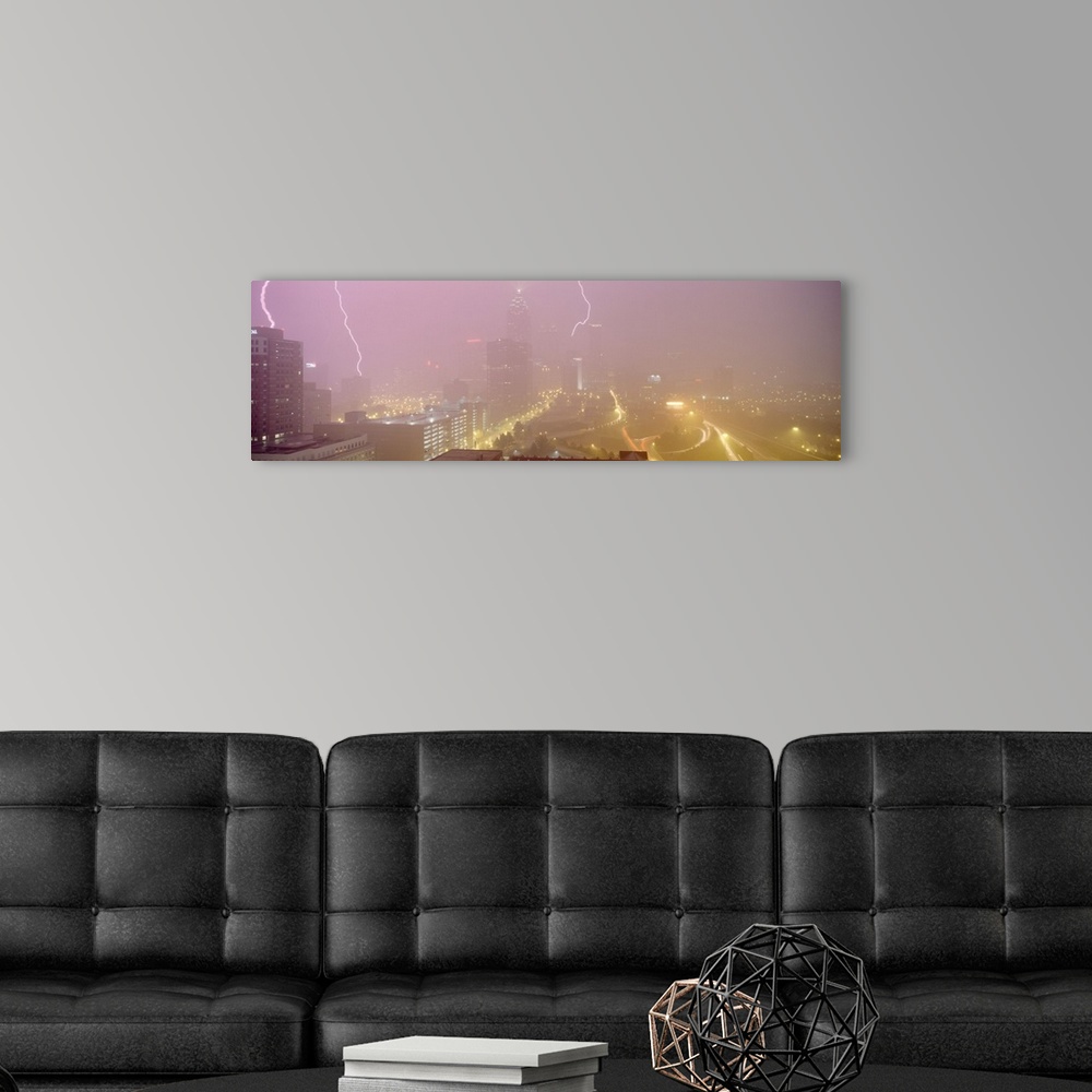 A modern room featuring Panoramic photograph of skyline with storm clouds and lightning bolts overhead.
