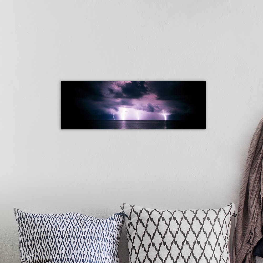 A bohemian room featuring Panoramic photograph of a dark, stormy sky, several bright lightening bolts striking the horizon ...