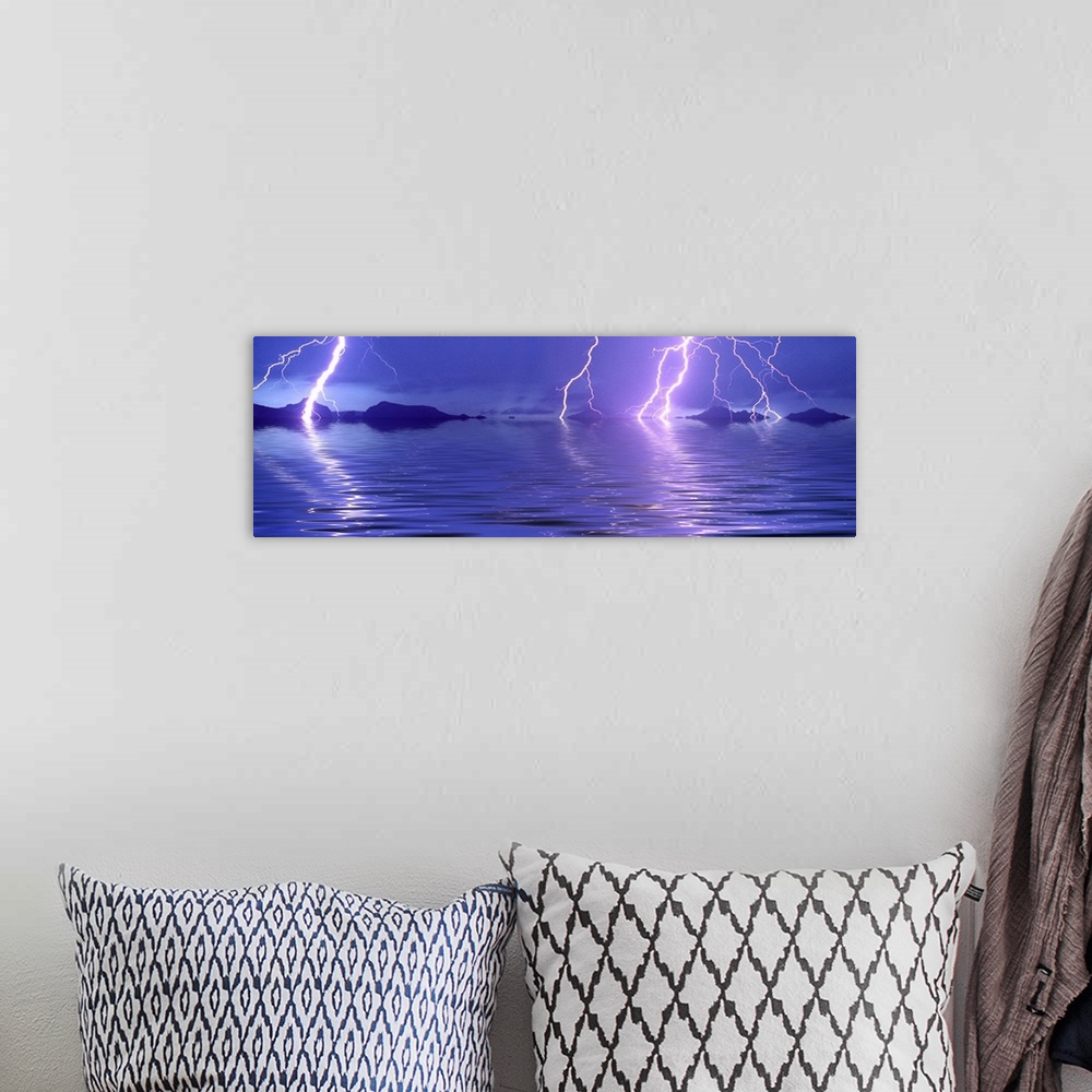 A bohemian room featuring Panoramic photograph of thunder bolts over the ocean at night.  There are mountains scattered in ...