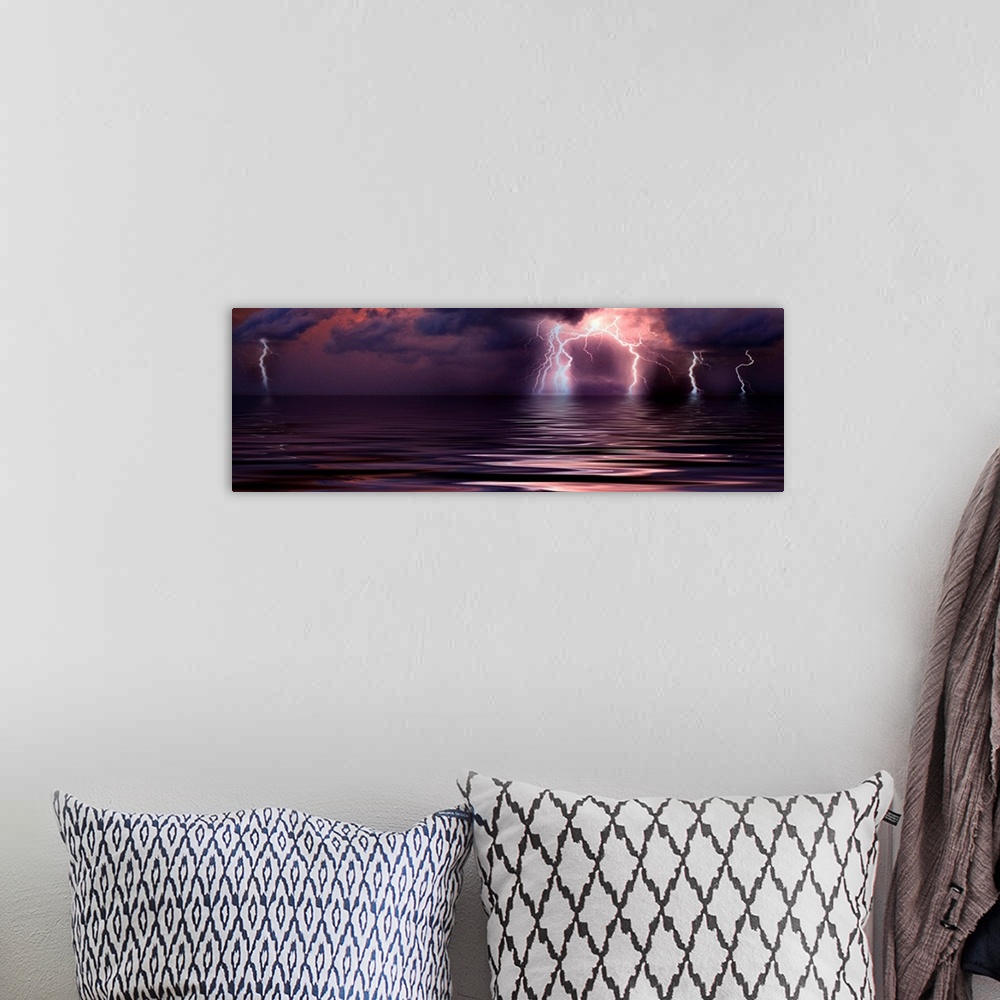 A bohemian room featuring Panoramic wall art of a photograph capturing a storm over the ocean at the moment lightening is s...