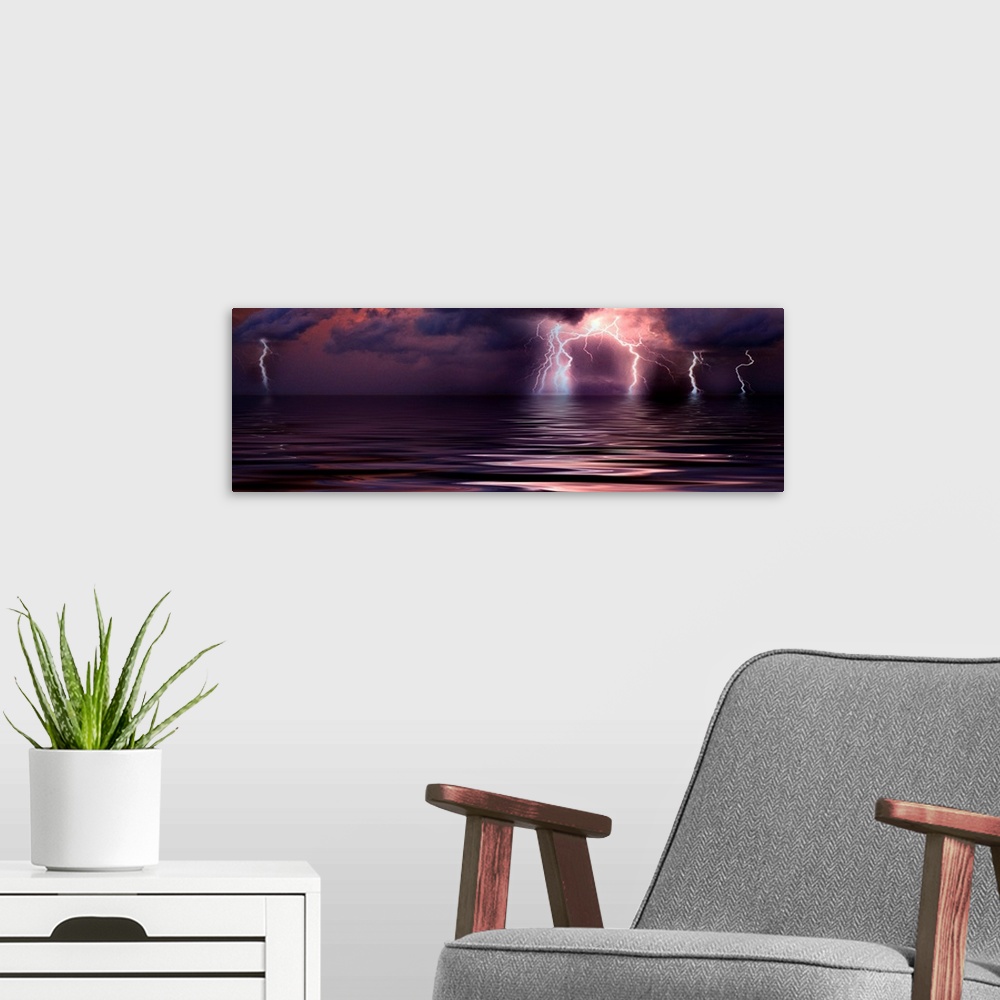 A modern room featuring Panoramic wall art of a photograph capturing a storm over the ocean at the moment lightening is s...