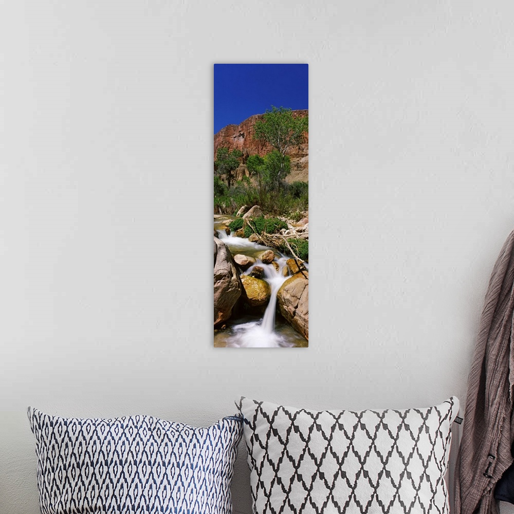 A bohemian room featuring Little Nankoweap Creek flowing through rocks, Arizona