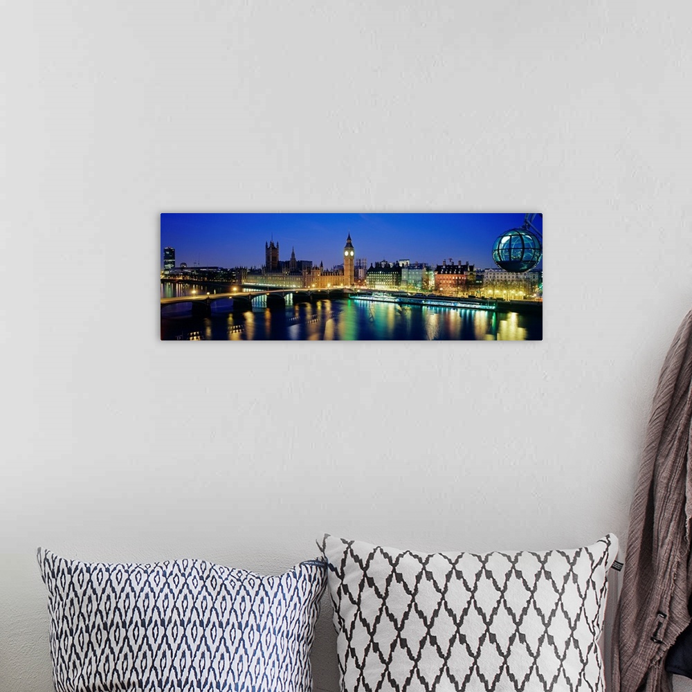 A bohemian room featuring Panoramic photograph showcases the capital of the United Kingdom at dusk.  The colorful lights of...