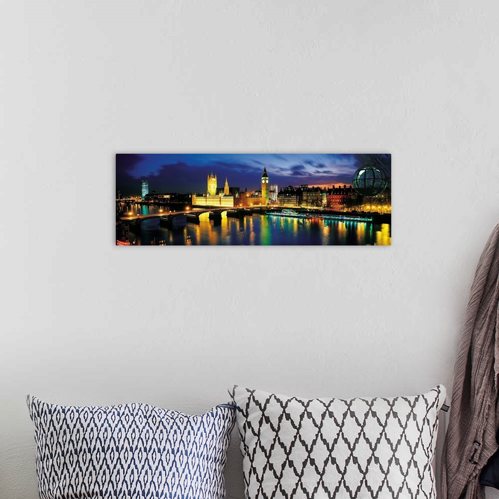 A bohemian room featuring Panoramic photograph shows the colorful lights across the skyline of London, England at dusk.  La...