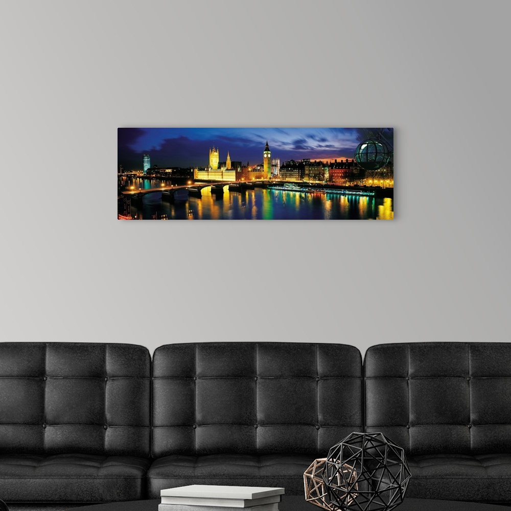 A modern room featuring Panoramic photograph shows the colorful lights across the skyline of London, England at dusk.  La...