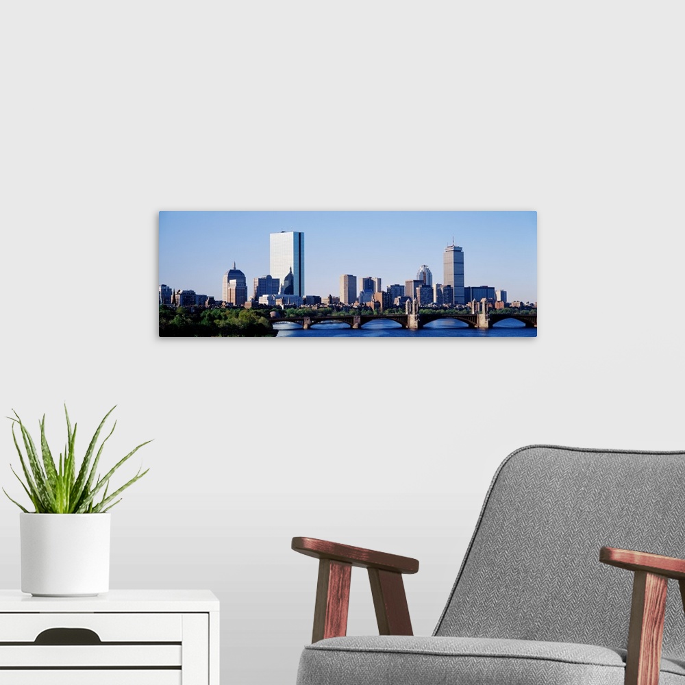 A modern room featuring Giant, landscape photograph of Longfellow Bridge in front of the Boston skyline in Massachusetts.