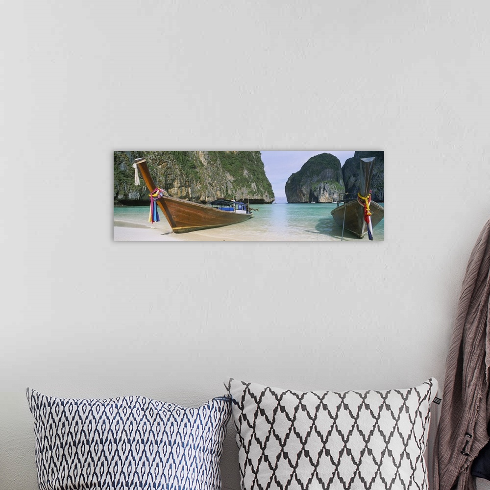 A bohemian room featuring Panoramic photograph of two big canoes docked in sand at the shoreline with huge rock formations ...