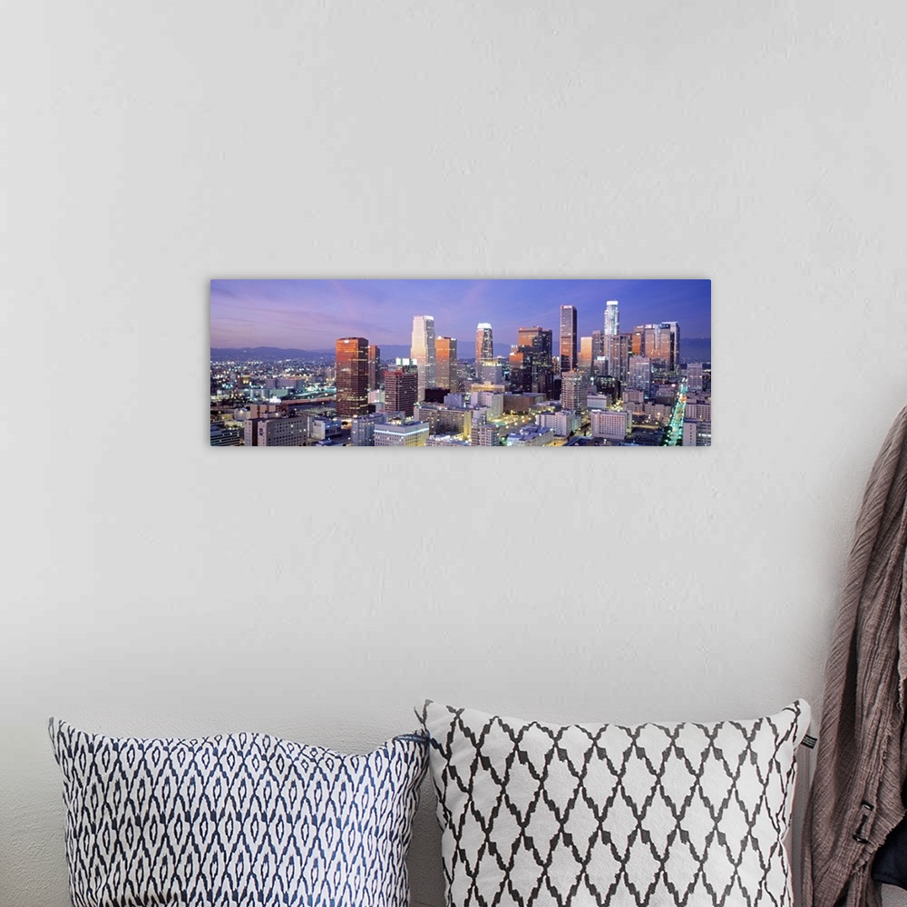 A bohemian room featuring This large panoramic piece shows many of the skyscrapers in downtown Los Angeles during dusk.