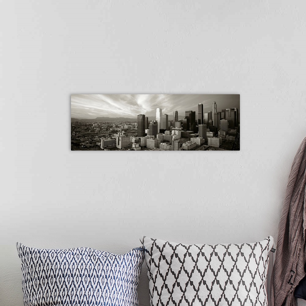 A bohemian room featuring Panoramic photograph of Los Angeles, CA skyline with mountains in the distance and clouds overhead.