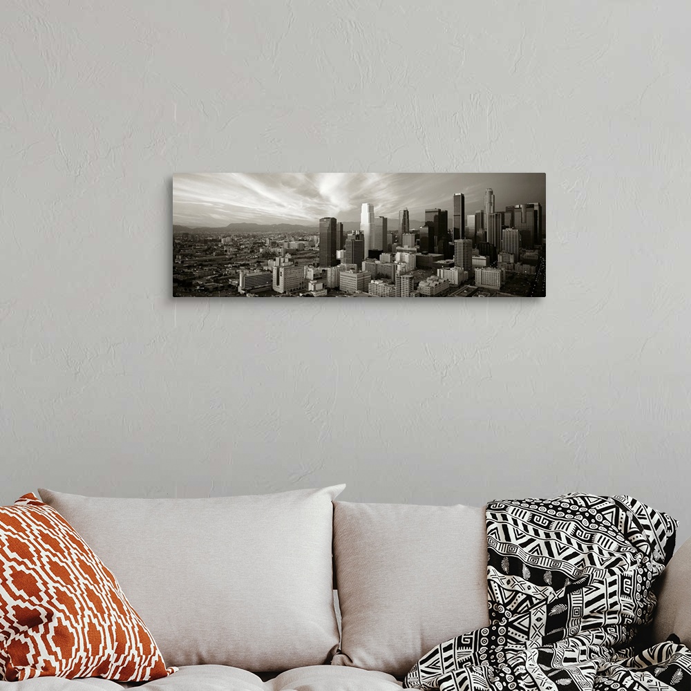 A bohemian room featuring Panoramic photograph of Los Angeles, CA skyline with mountains in the distance and clouds overhead.