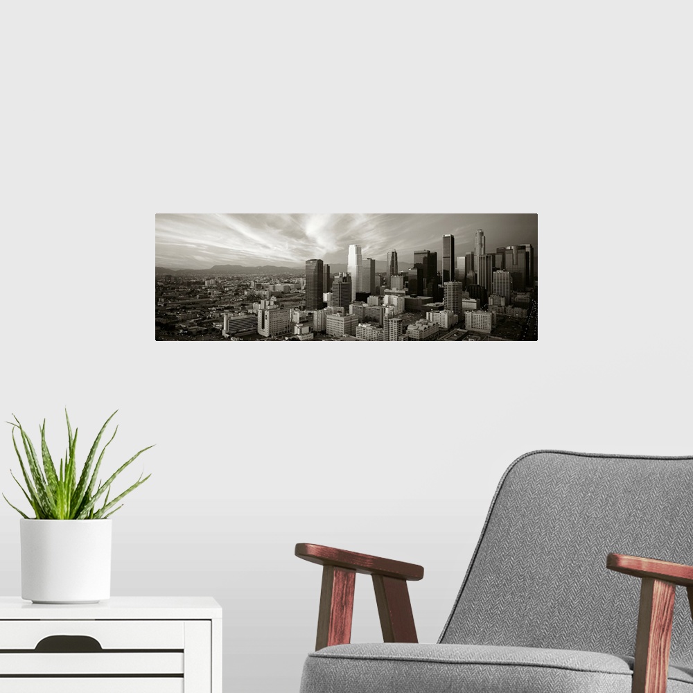A modern room featuring Panoramic photograph of Los Angeles, CA skyline with mountains in the distance and clouds overhead.