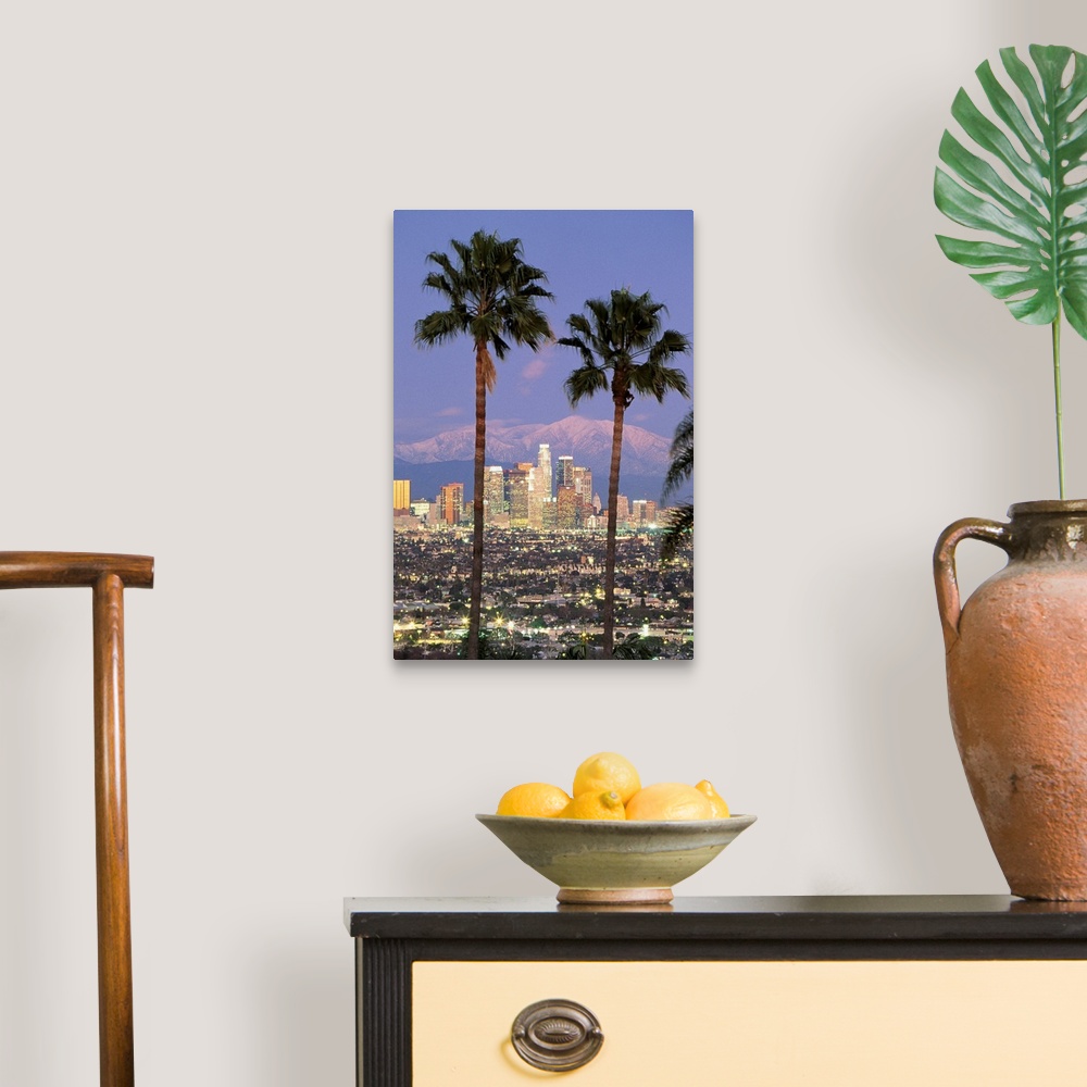 A traditional room featuring A vertical photograph of skyscrapers in the Los Angelesos skyline framed by two palm trees and mo...