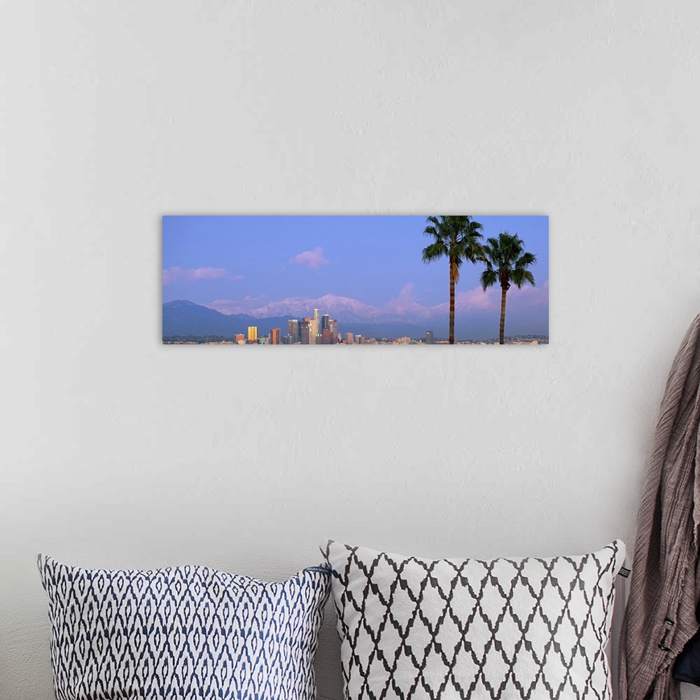 A bohemian room featuring Panoramic photograph of skyline and palm trees under a cloudy sky with mountain silhouettes in th...