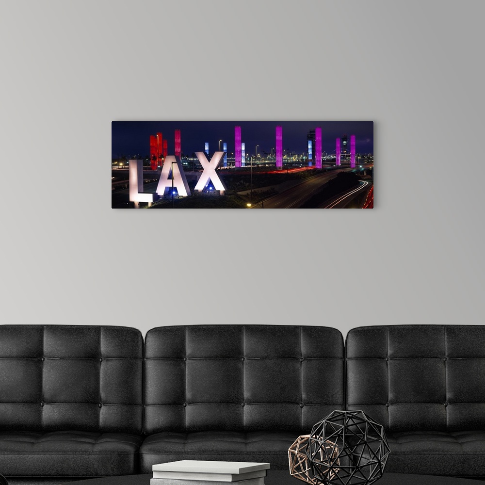 A modern room featuring Large panoramic photograph of the Los Angeles International Airport with large LAX letters by a h...