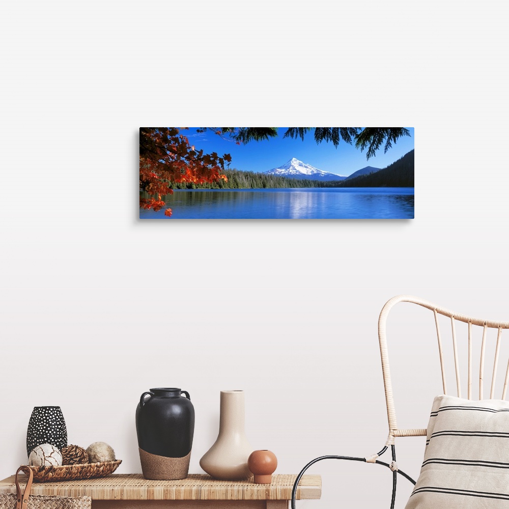 A farmhouse room featuring In the wilderness a mountain peak reflects in a lake surrounded by trees on this panoramic wall art.