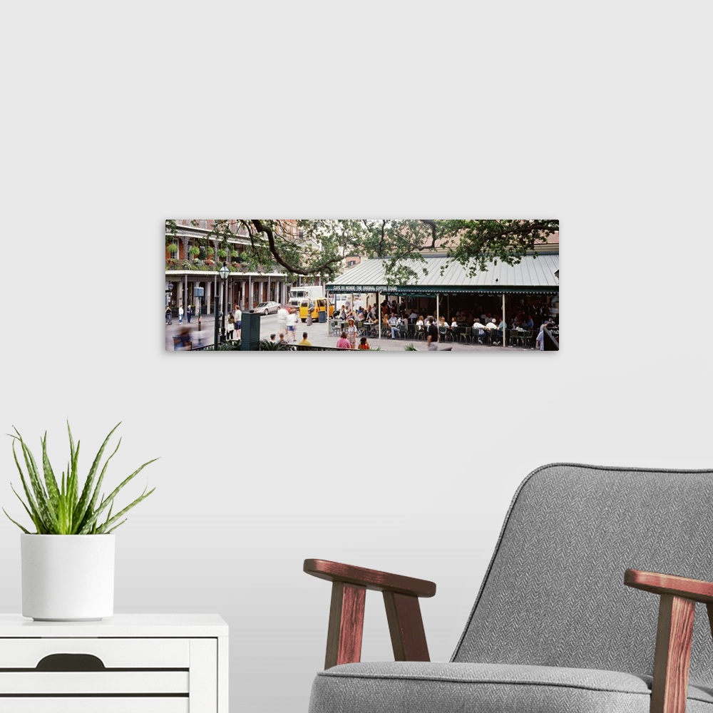 A modern room featuring Large panoramic photograph of the French quarter in New Orleans with a tree hovering over and an ...