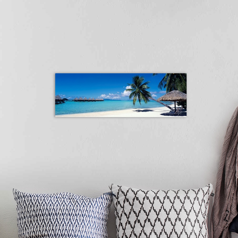 A bohemian room featuring This wall art is a restful beach retreat with clear water and skies captured in a panoramic photo...