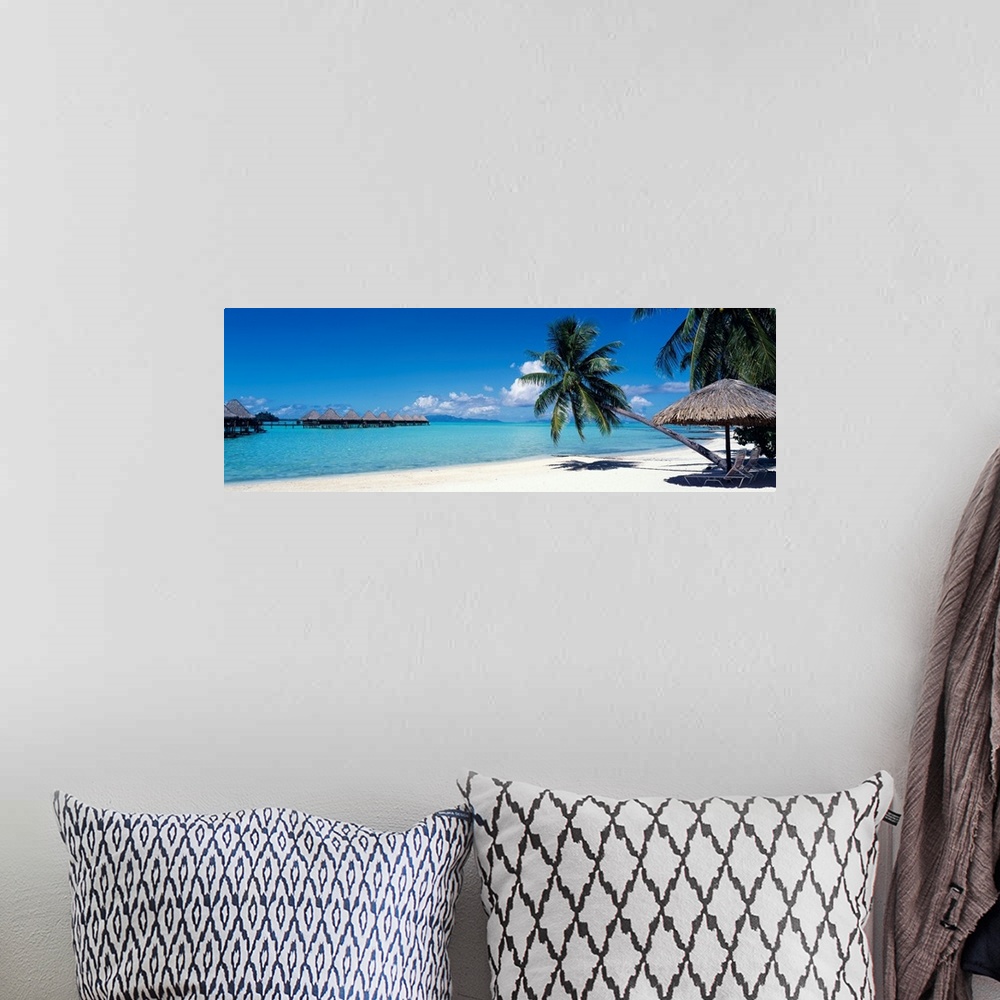 A bohemian room featuring This wall art is a restful beach retreat with clear water and skies captured in a panoramic photo...